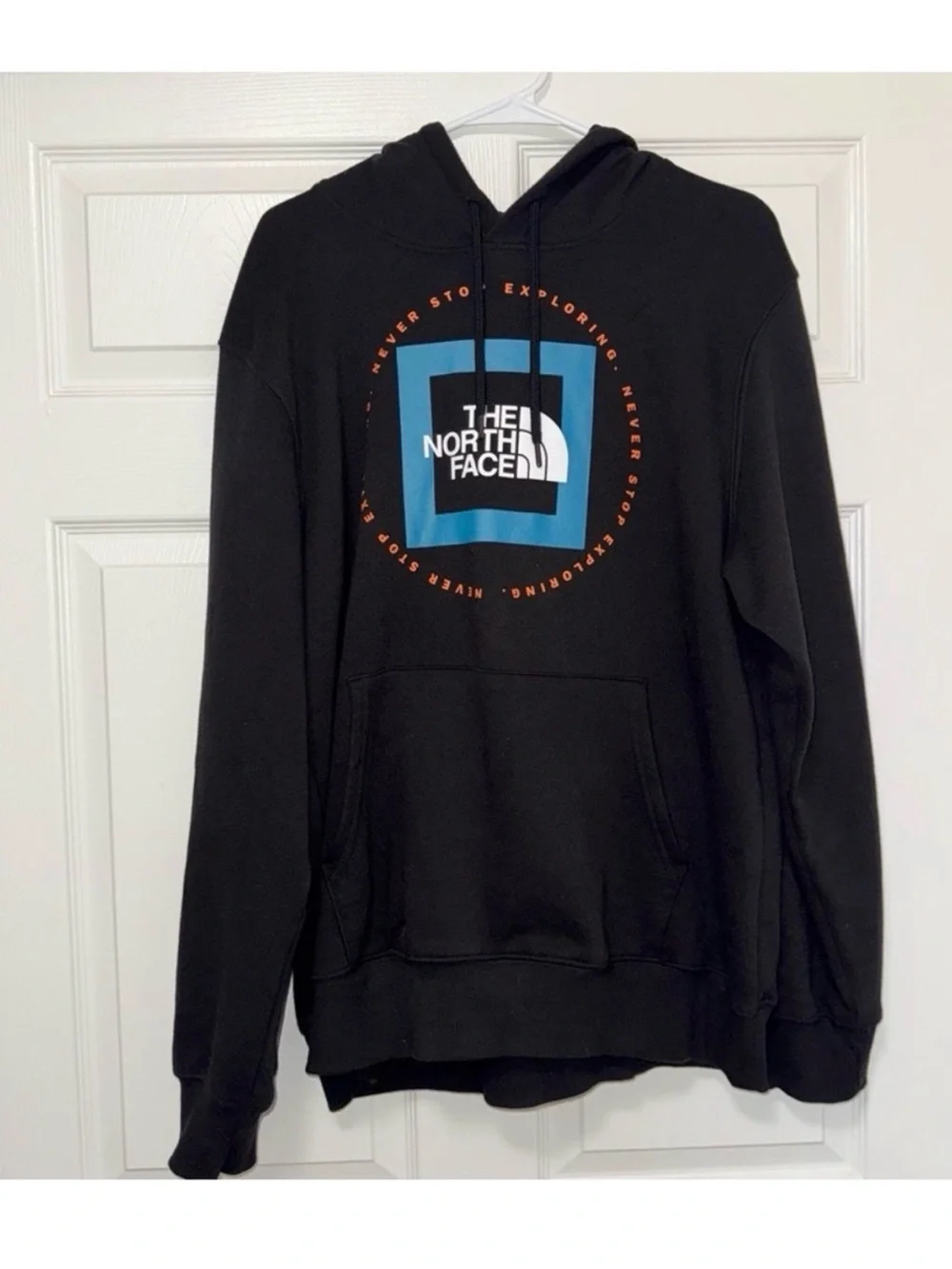 The North Face Black Pullover Hoodie with Blue Logo and Orange Accents